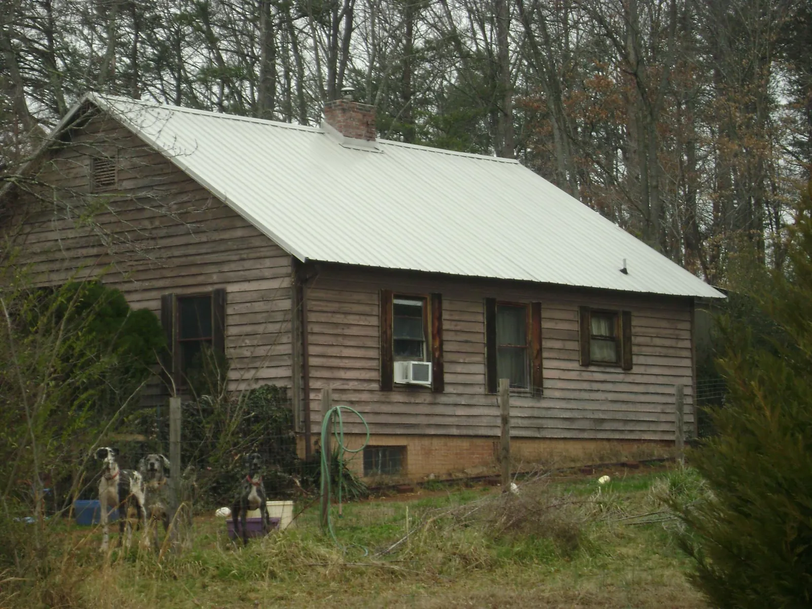White metal roof on an old wood sided farmhouse, from a Metal Roof Installation job in Winthrop